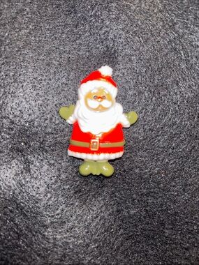 Vintage plastic pin brooch features a waving Santa designed by Hallmark. 1970’s